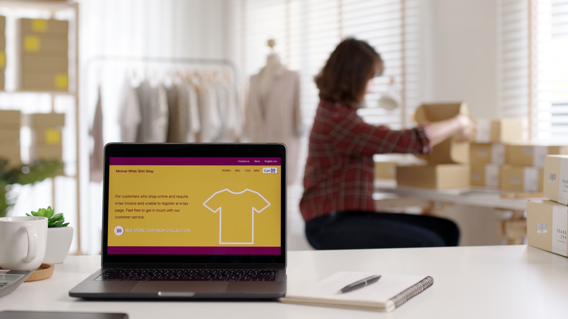 UX UI smart website notebook screen on desk table home office designer studio e-commerce salepage media startup sme with asia busy woman work supply chain logistic delivery wifi network.